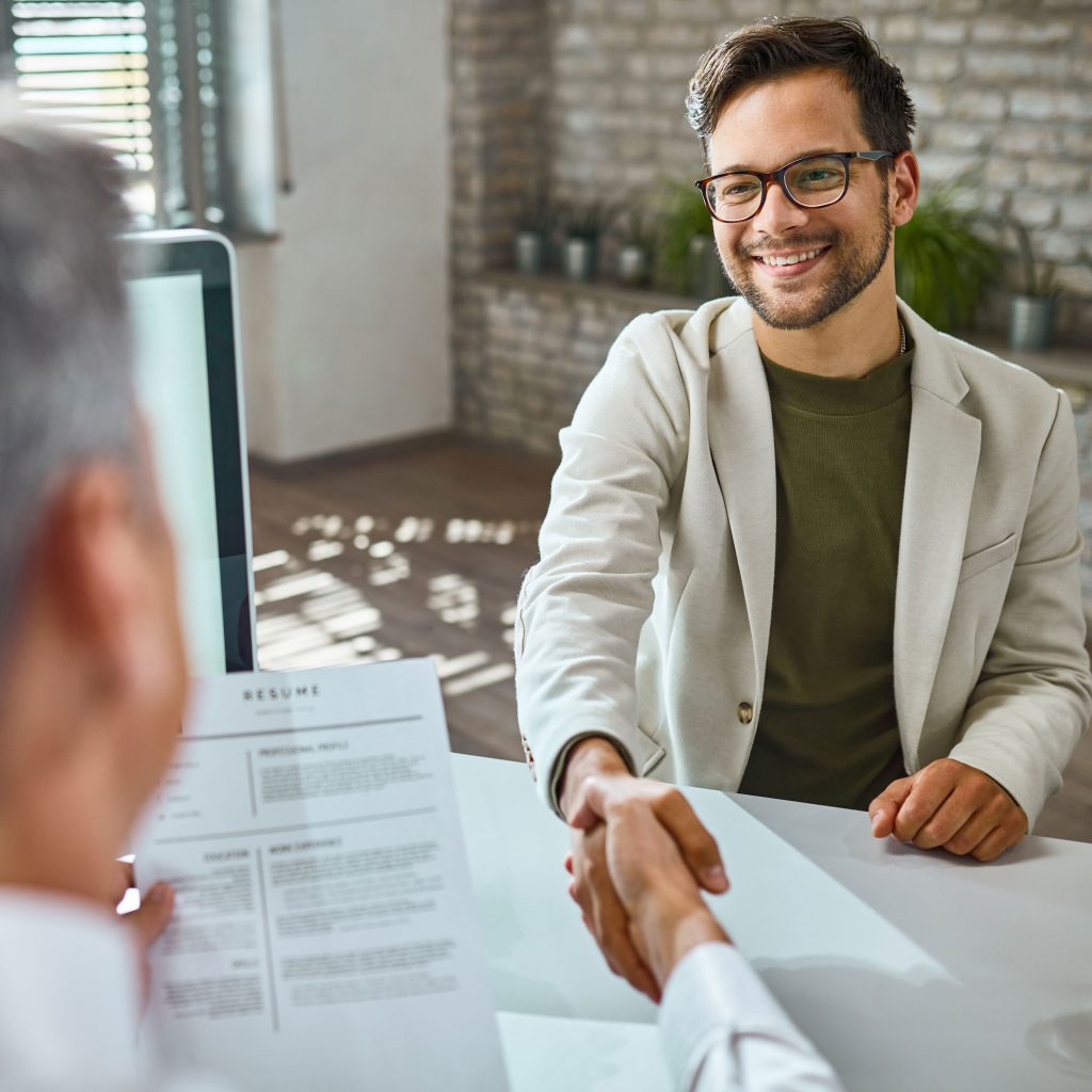 happy male candidate greeting member human resource team job interview office web