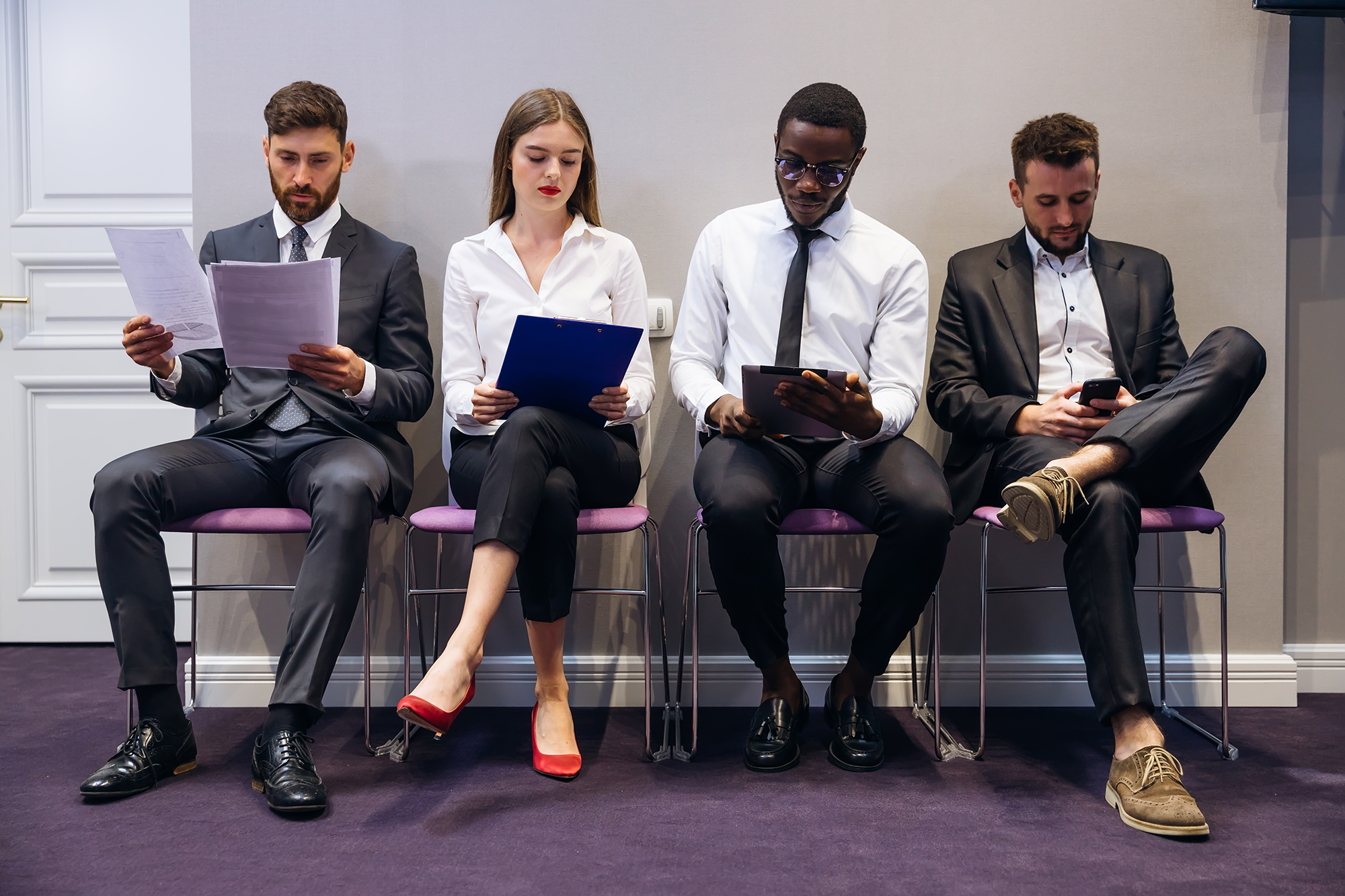 various job candidates sit line waiting interview looking through gadgets hiring personnel management concept web